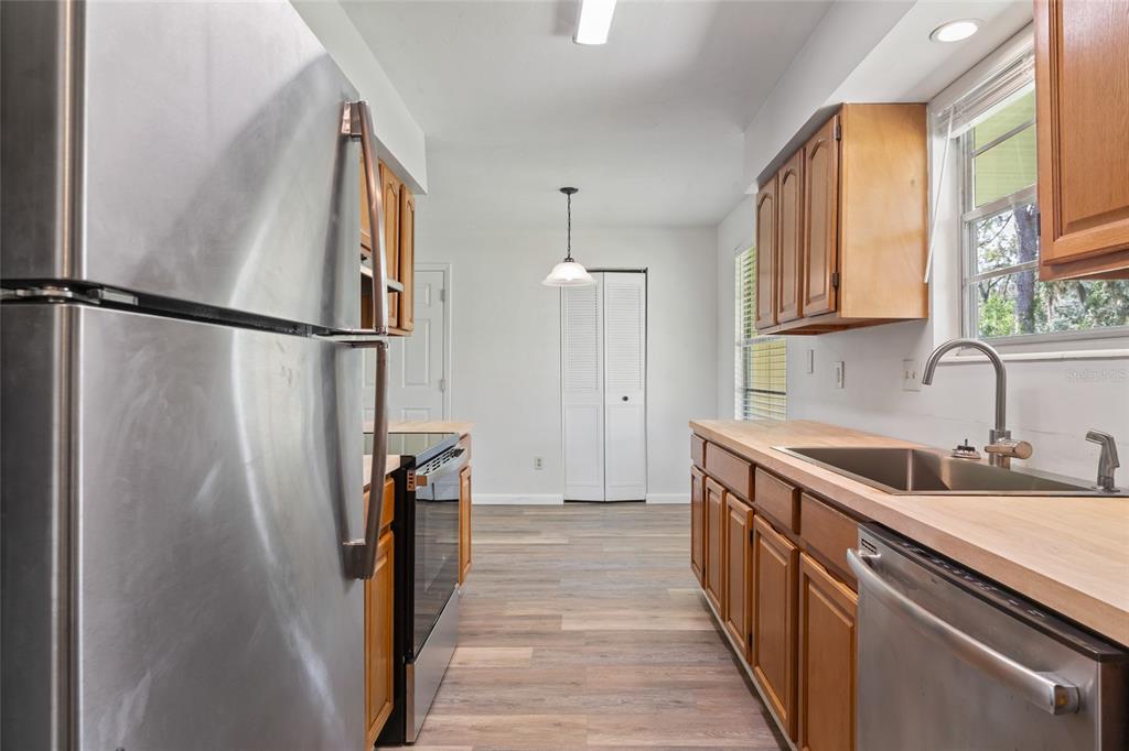 6401 Southwest 78th Street Gainesville, FL 32608 - Photo 7 of 29 a kitchen with sink a refrigerator and a stove