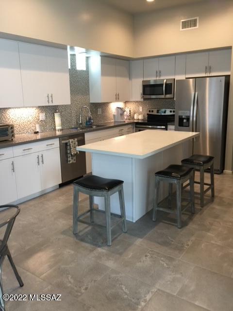 866 East Millenium Court Tucson, AZ 85719 - Photo 6 of 15 a kitchen with kitchen island a cabinets appliances and a counter top space
