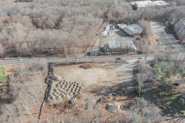 a view of a yard with wooden fence
