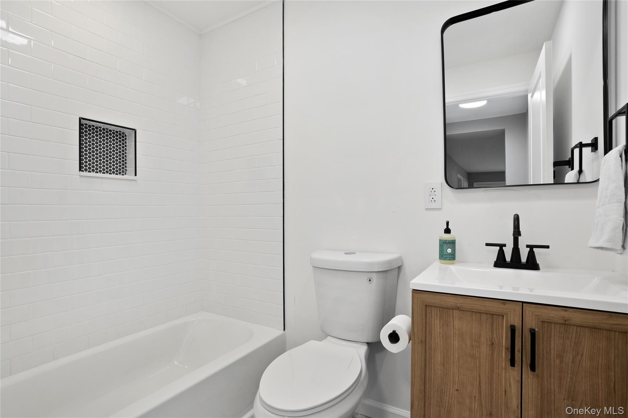 517 East Mountain Road North, Unit 515517 Cold Spring, NY 10516 - Photo 22 of 30 a bathroom with a toilet sink vanity tub and mirror