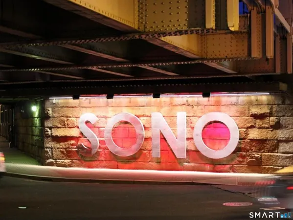 a bathroom with a sink a vanity and stainless steel appliances