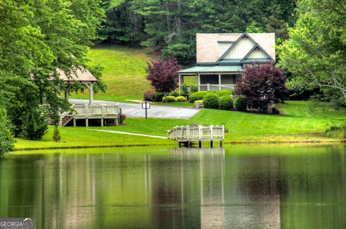 Lot 141 Fox Ridge, Unit 141 Blairsville, GA 30512 - Photo 26 of 31 a front view of a house with a yard table and chairs