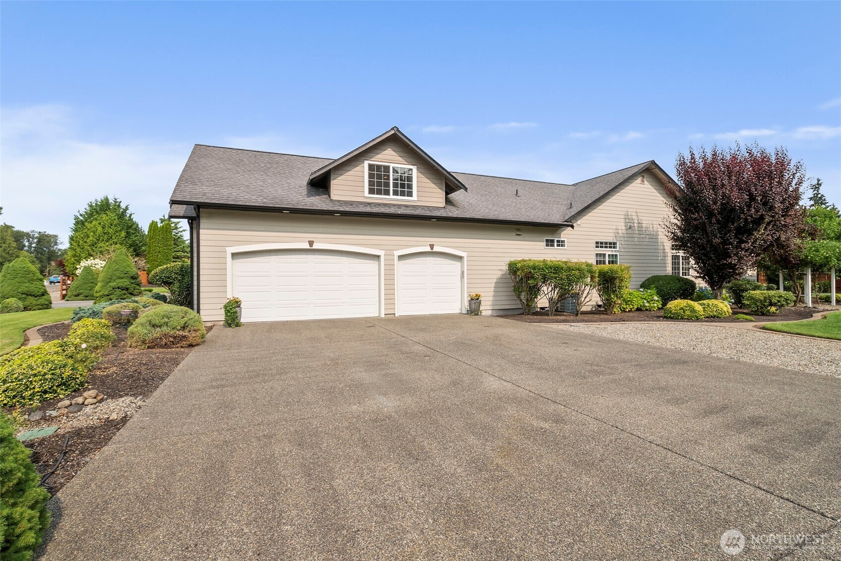 9609 346th Street South Roy, WA 98580 - Photo 32 of 37 a front view of a house with a yard and garage