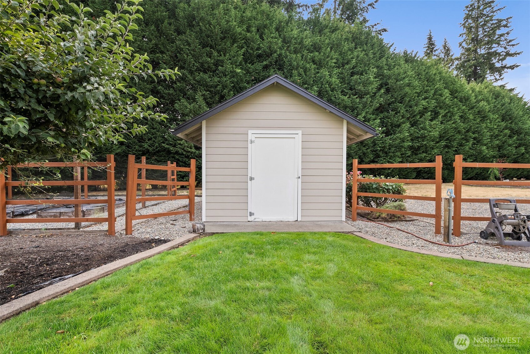 9609 346th Street South Roy, WA 98580 - Photo 34 of 37 a view of a house with a yard and a wooden fence