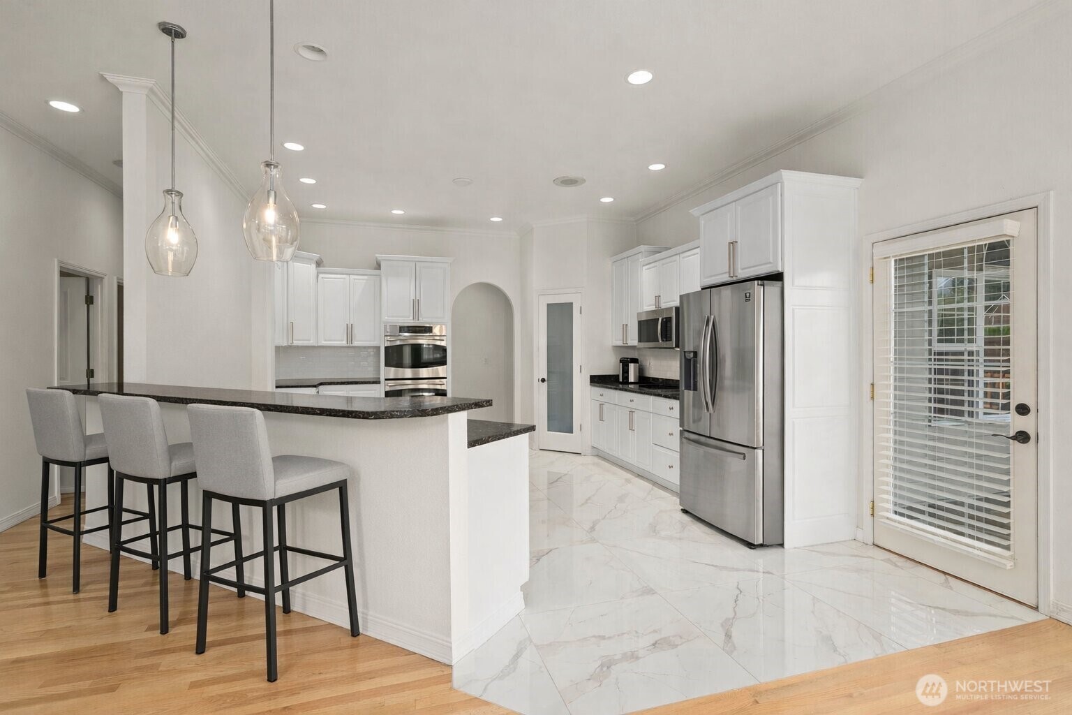 9609 346th Street South Roy, WA 98580 - Photo 9 of 31 a kitchen with stainless steel appliances kitchen island granite countertop a refrigerator and a stove top oven