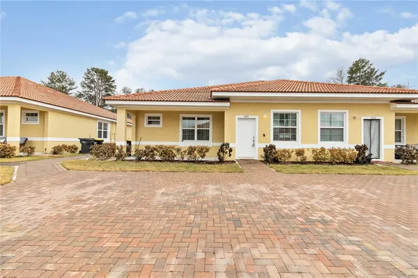 a front view of house with yard and outdoor seating