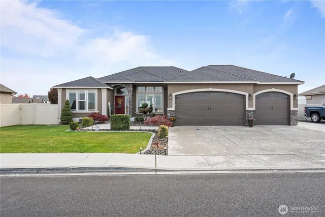 a front view of a house with a yard and garage