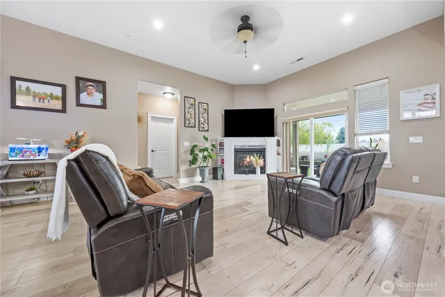 a living room with furniture a flat screen tv and a fireplace