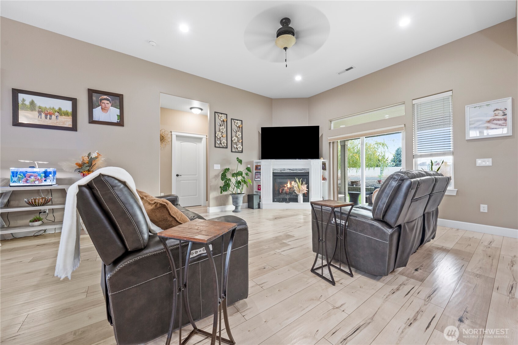 1830 East Madera Street Othello, WA 99344 - Photo 23 of 35 a living room with furniture a flat screen tv and a fireplace