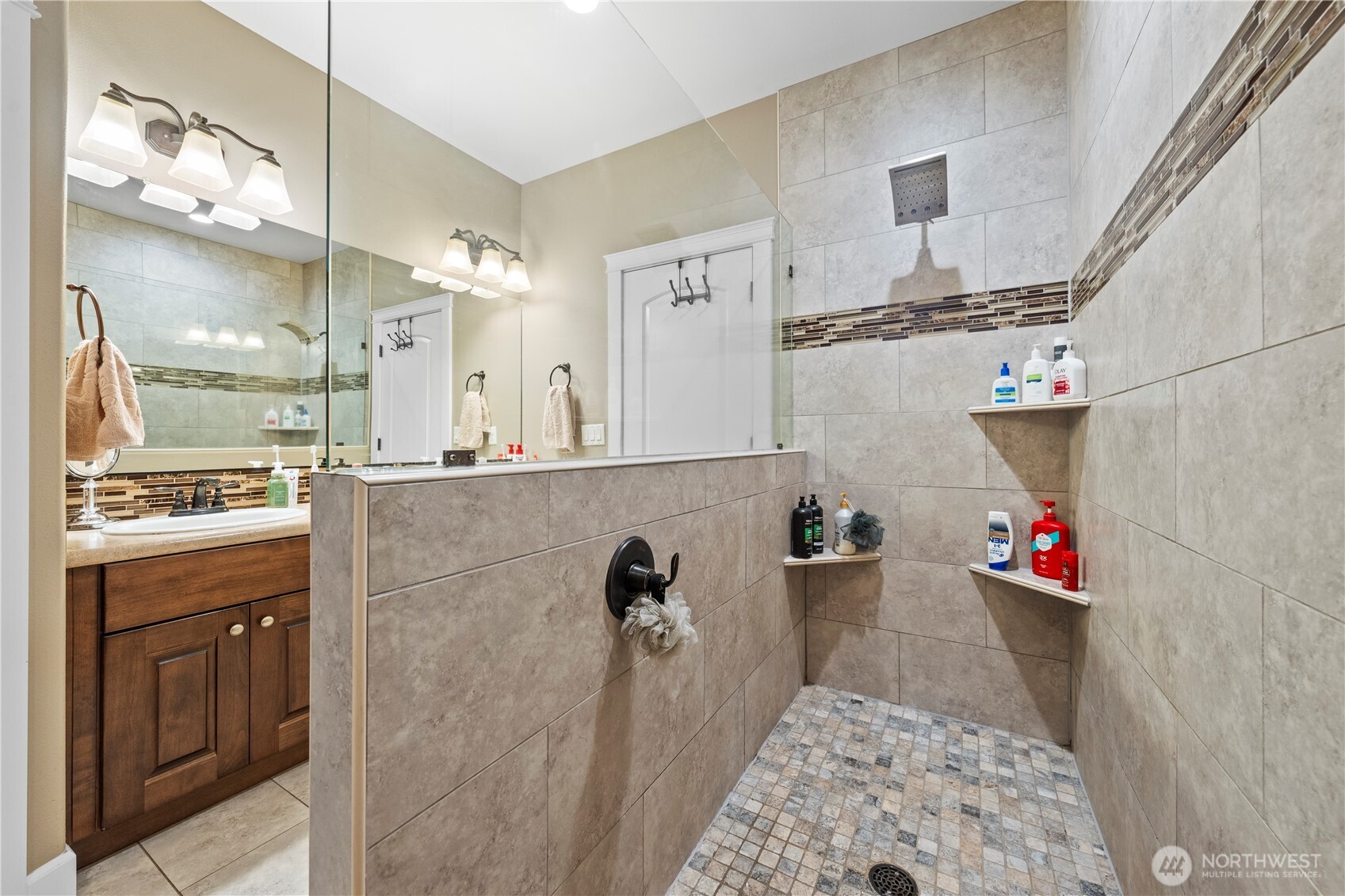 1830 East Madera Street Othello, WA 99344 - Photo 25 of 35 a bathroom with a sink mirror and shower