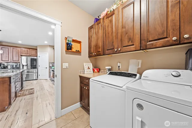 a view of washer and dryer with kitchen view