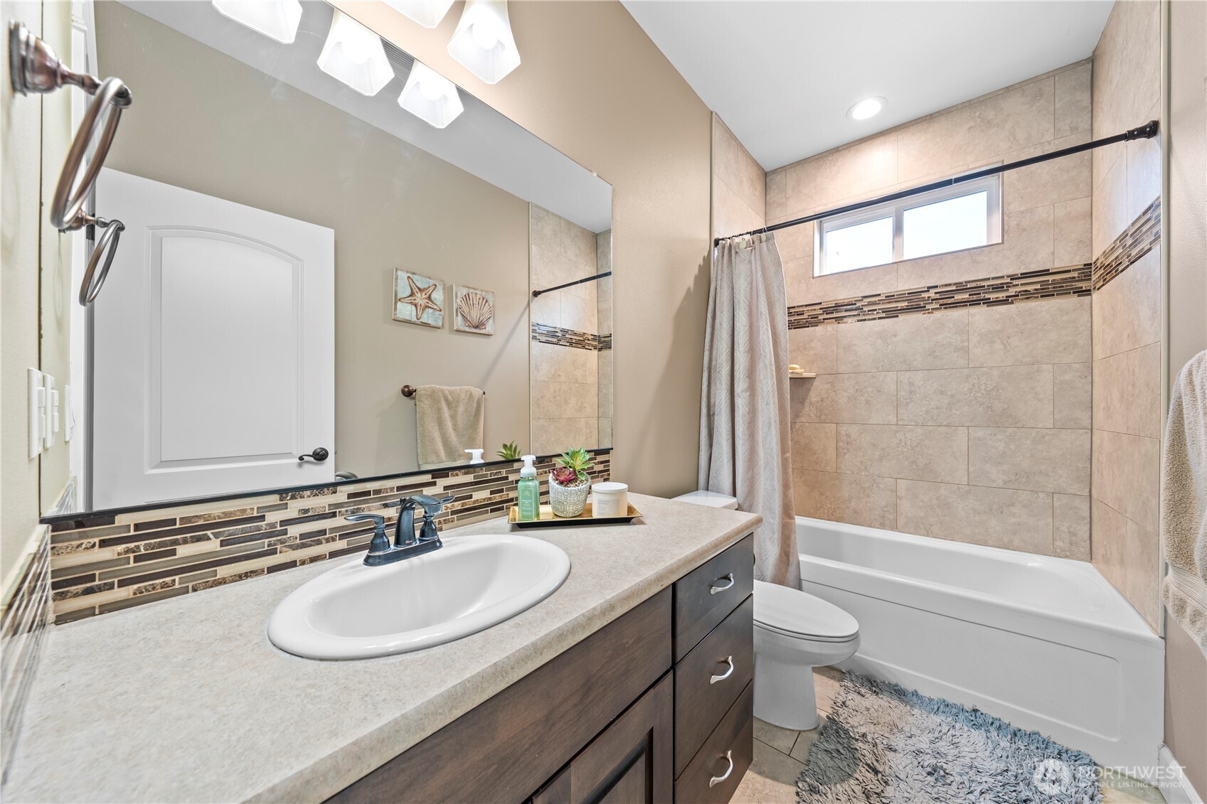 1830 East Madera Street Othello, WA 99344 - Photo 30 of 35 a bathroom with a sink a toilet a mirror a bathtub and shower