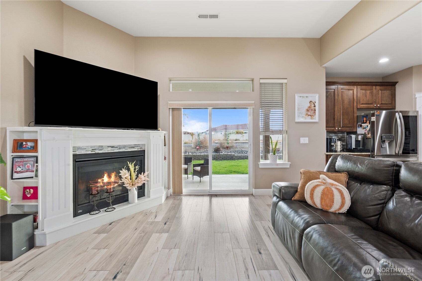 1830 East Madera Street Othello, WA 99344 - Photo 8 of 35 a living room with furniture a flat screen tv and a fireplace
