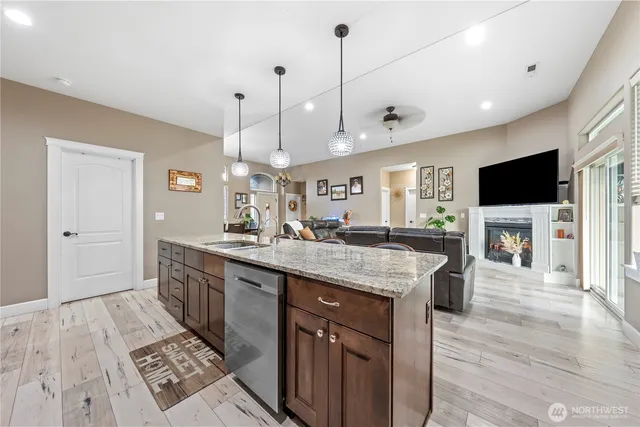 a large kitchen with stainless steel appliances kitchen island granite countertop a large island in the center