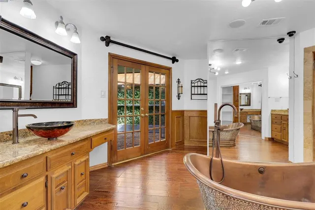 a kitchen with granite countertop a sink and wooden floors