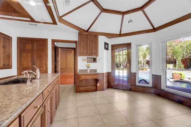 a bathroom with a granite countertop sink a toilet and bathtub