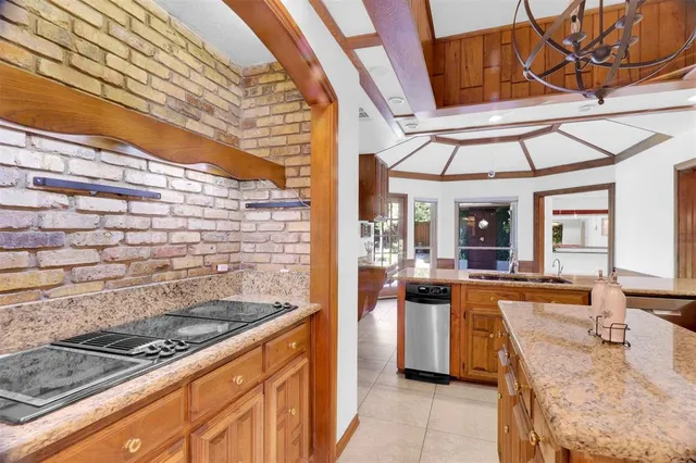 a kitchen with stainless steel appliances granite countertop a sink and cabinets