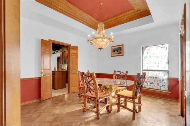 a dining room with furniture and chandelier kitchen view