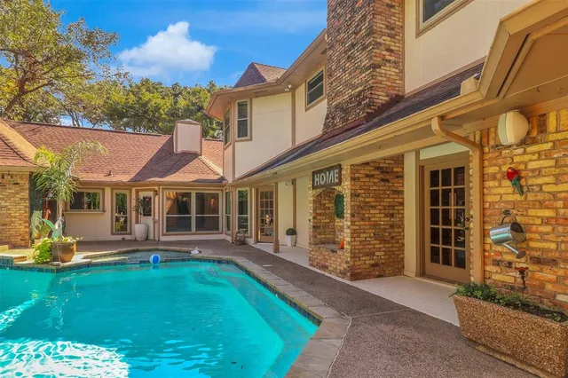 a front view of a house with swimming pool having outdoor seating