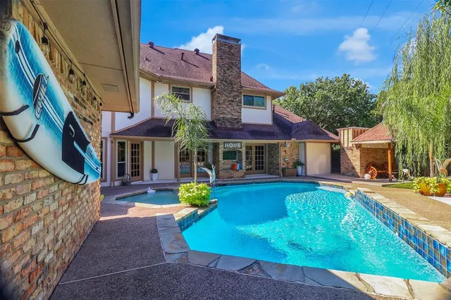 a view of a swimming pool with a patio