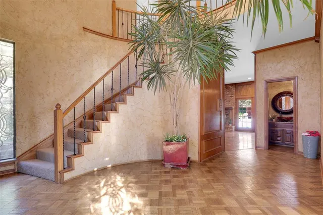a view of an entryway with wooden floor and door