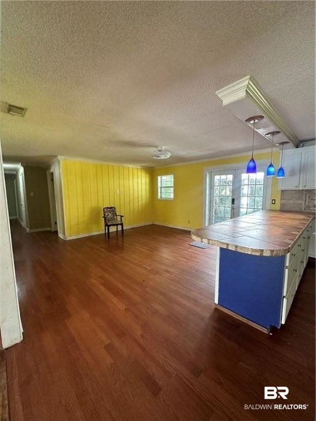 9151 Old Mobile Road Daphne, AL 36527 - Photo 6 of 23 Interior space featuring wood walls, dark hardwood / wood-style flooring, and a textured ceiling