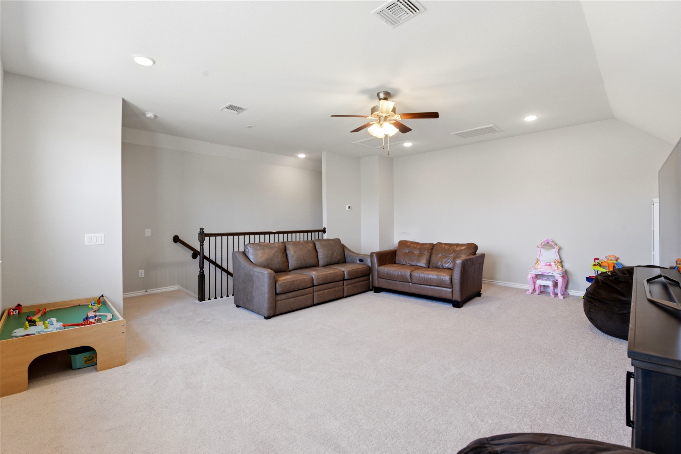 17834 Maple Ash Drive Spring, TX 77379 - Photo 31 of 50 Spacious, carpeted living area upstairs with neutral walls, featuring a ceiling fan and comfortable seating.