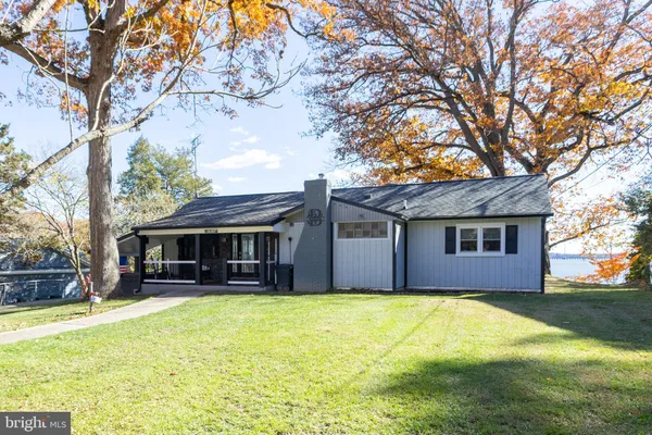 a house that has a tree in front of it