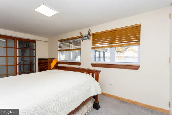 a bed sitting in a bedroom next to a window