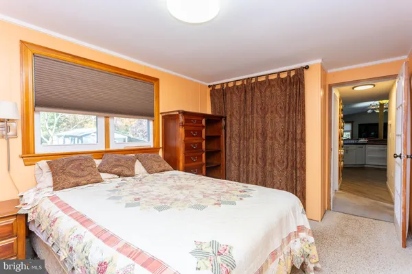 a bed sitting in a bedroom next to a window