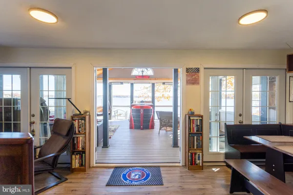 a view of hall way with furniture and wooden floor
