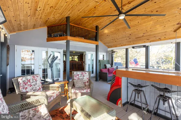 a living room with furniture a floor to ceiling window and outdoor view