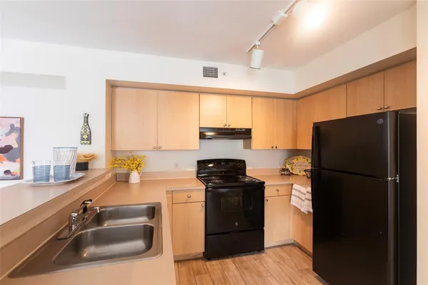 a kitchen with a refrigerator stove and sink