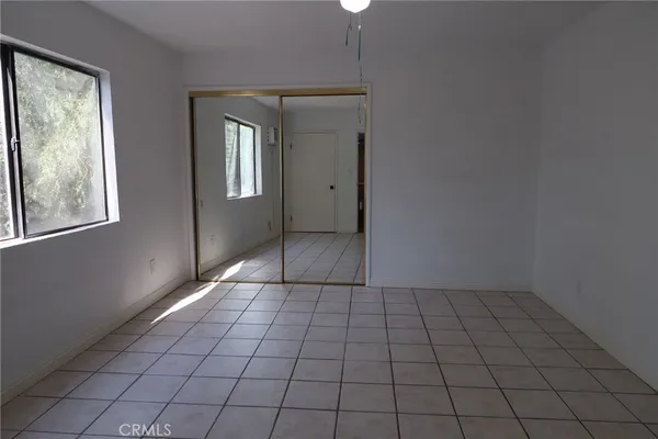 a view of a hallway to rooms