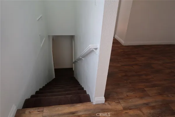 a view of a small space with wooden floor and a window