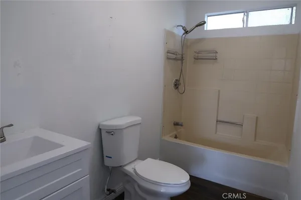 a bathroom with a toilet a sink and shower