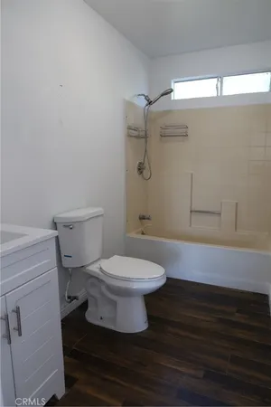 a view of walk in closet with wooden floor
