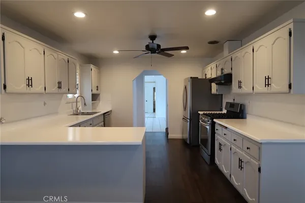 a kitchen with stainless steel appliances a sink stove and refrigerator