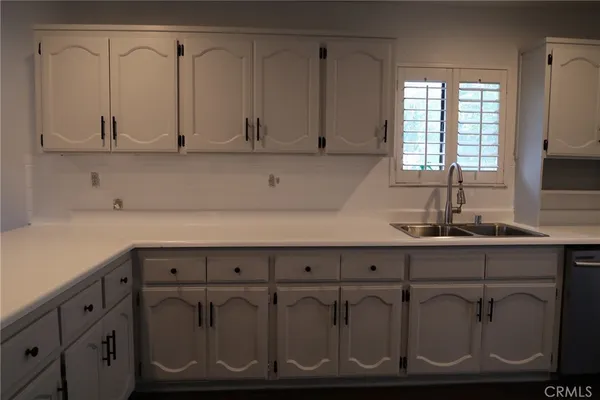 a kitchen with a sink and cabinets