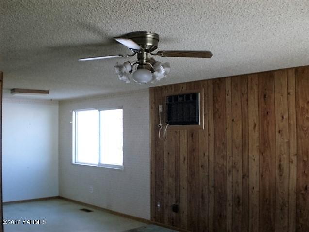 131 Webert Road Tieton, WA 98947 - Photo 14 of 17 a view of a livingroom with a ceiling fan and window
