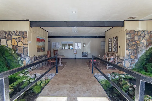 a large kitchen with a large counter top stainless steel appliances and cabinets