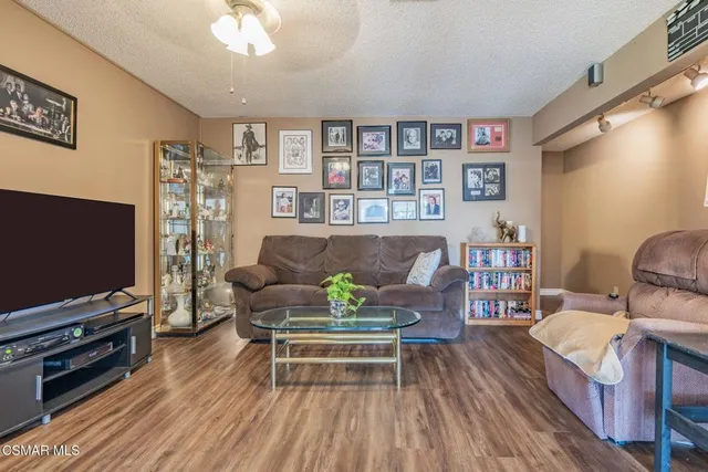 a bedroom with a large bed and a flat tv screen on dresser