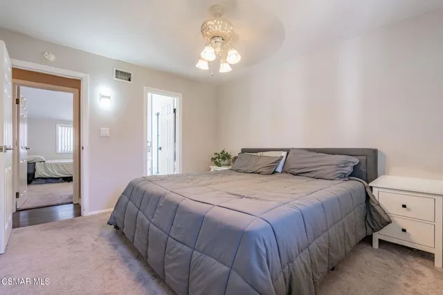 a kitchen with granite countertop white cabinets and stainless steel appliances