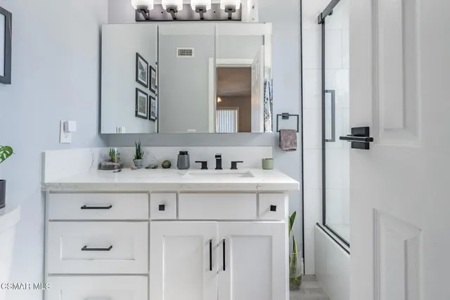 a view of a livingroom with furniture and floor to ceiling window