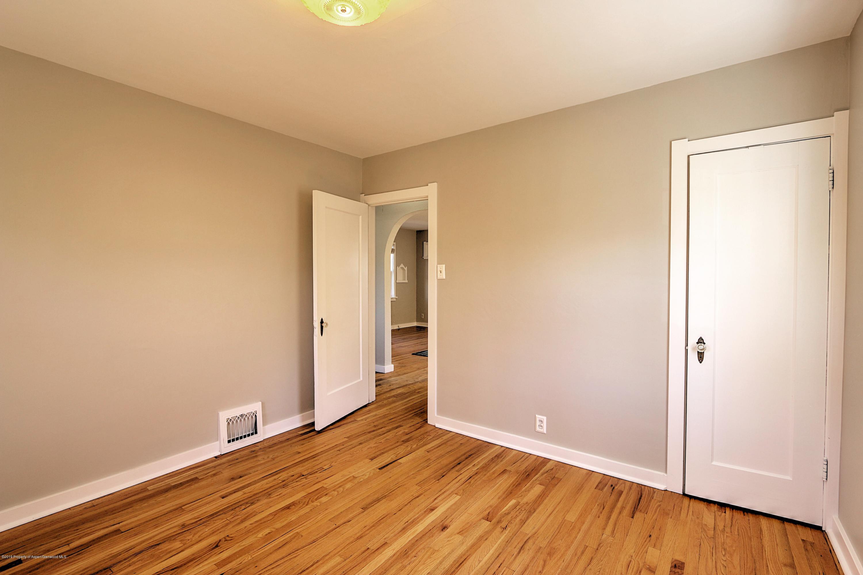 721 East Avenue Rifle, CO 81650 - Photo 13 of 24 a view of an empty room with wooden floor