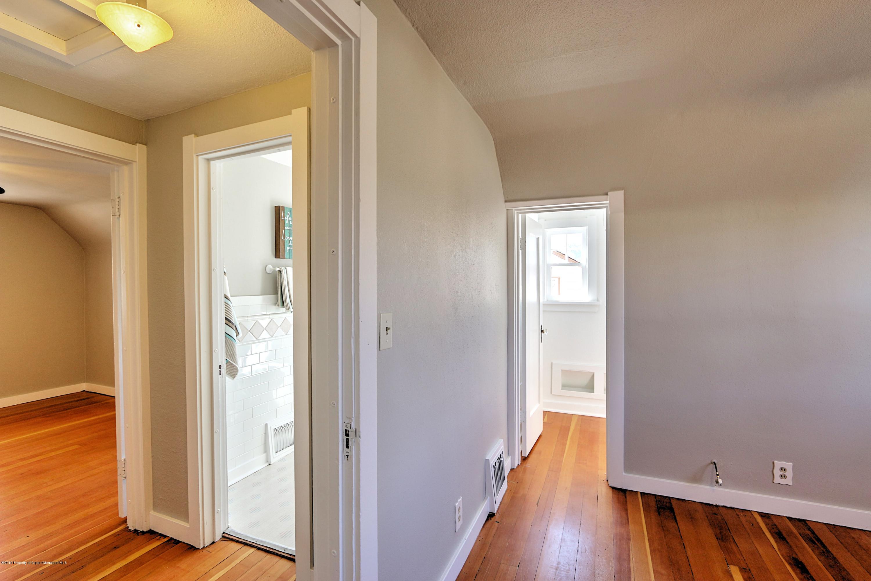 721 East Avenue Rifle, CO 81650 - Photo 16 of 24 a view of a hallway with wooden floor