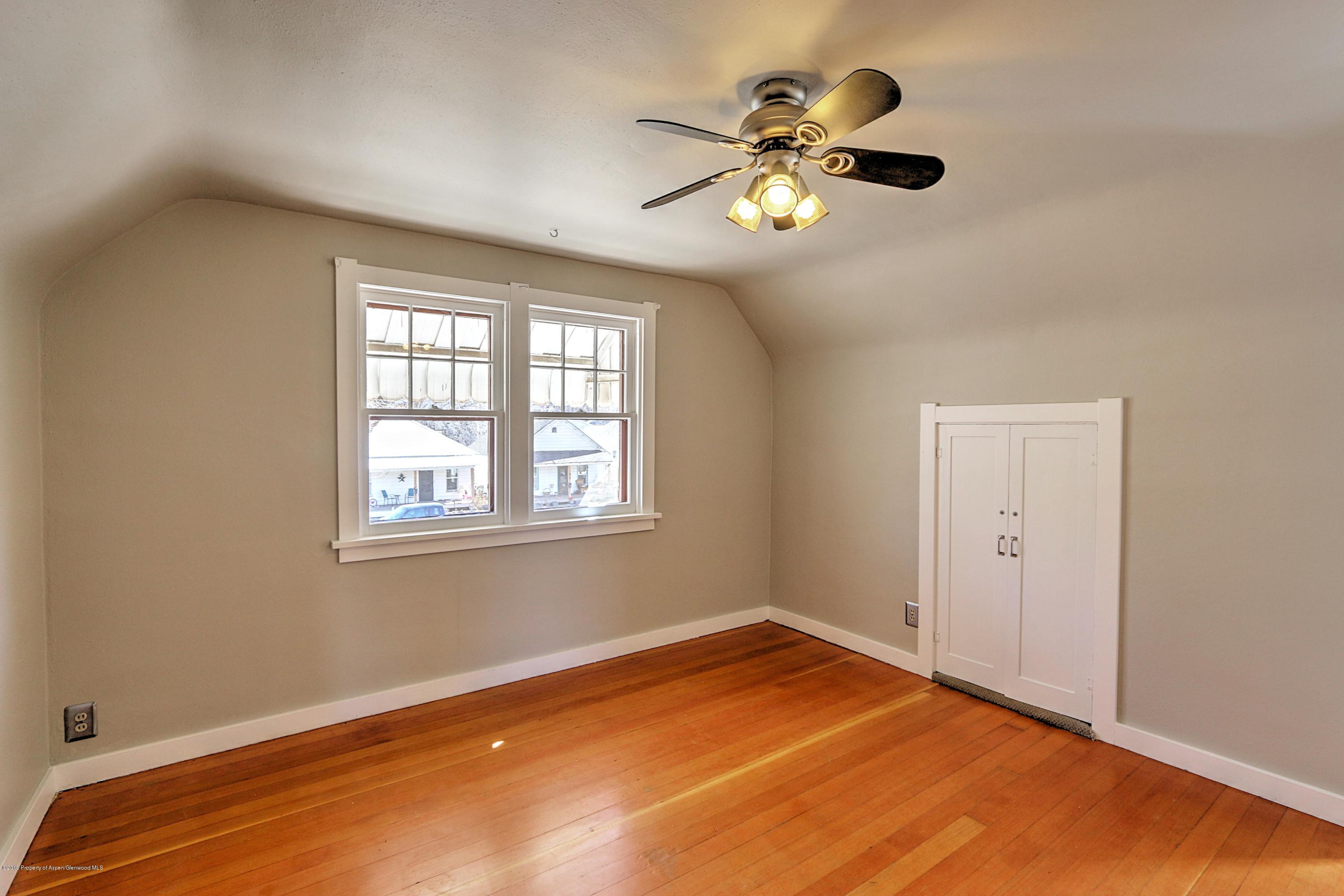 721 East Avenue Rifle, CO 81650 - Photo 20 of 24 a view of an empty room with chandelier fan and a window
