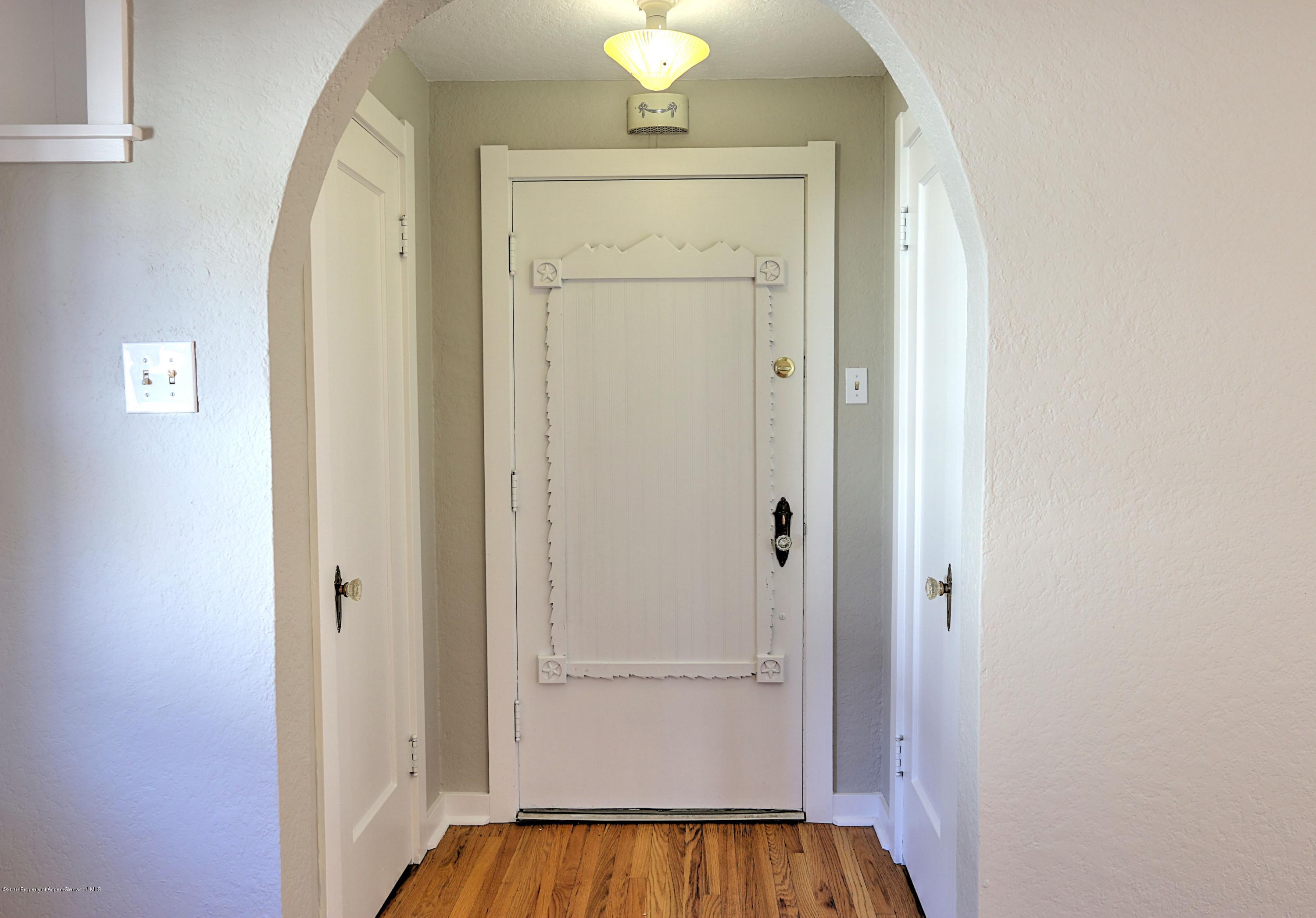 721 East Avenue Rifle, CO 81650 - Photo 3 of 24 a view of a hallway with wooden floor and closet