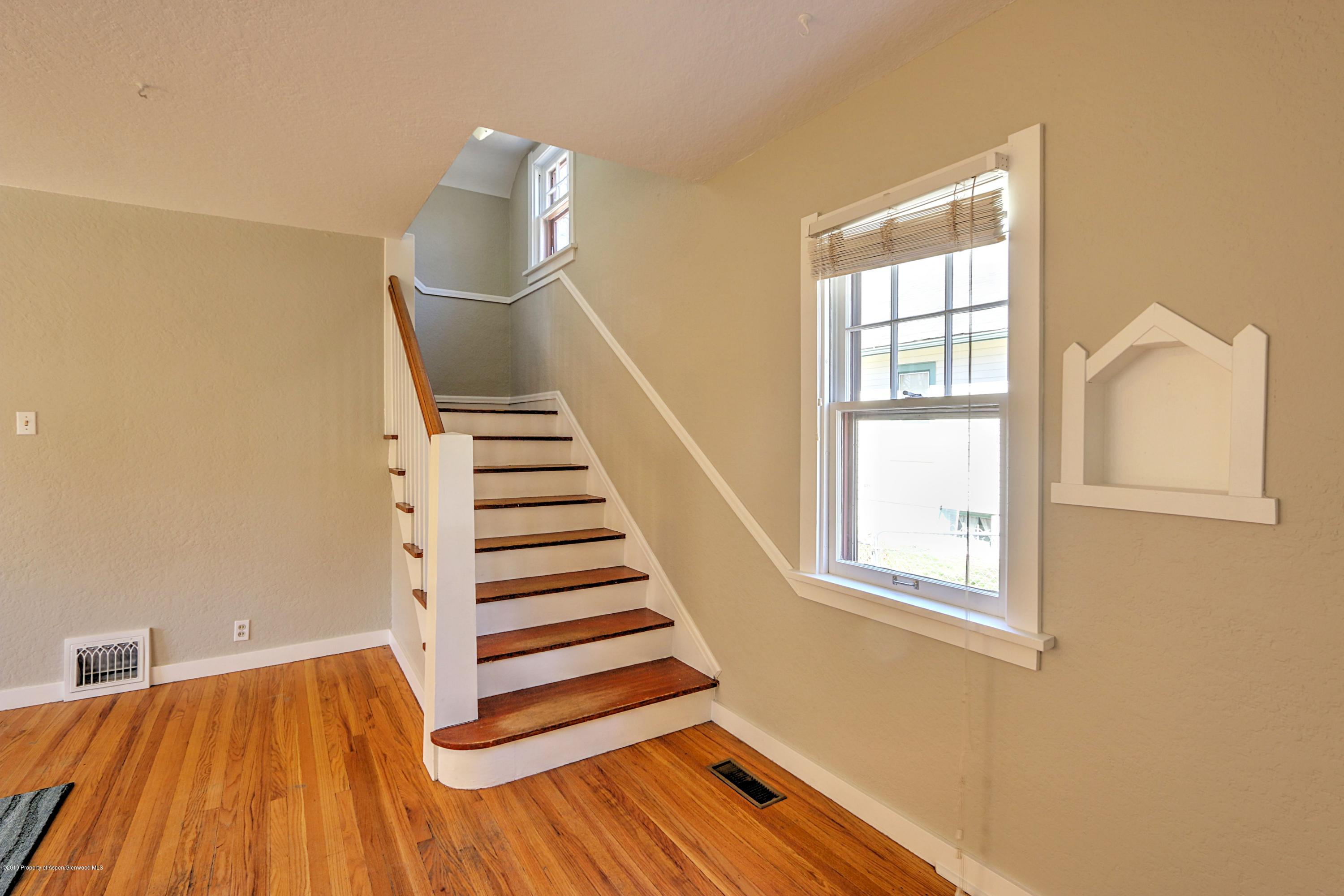 721 East Avenue Rifle, CO 81650 - Photo 5 of 24 a view of wooden floor and windows in a room
