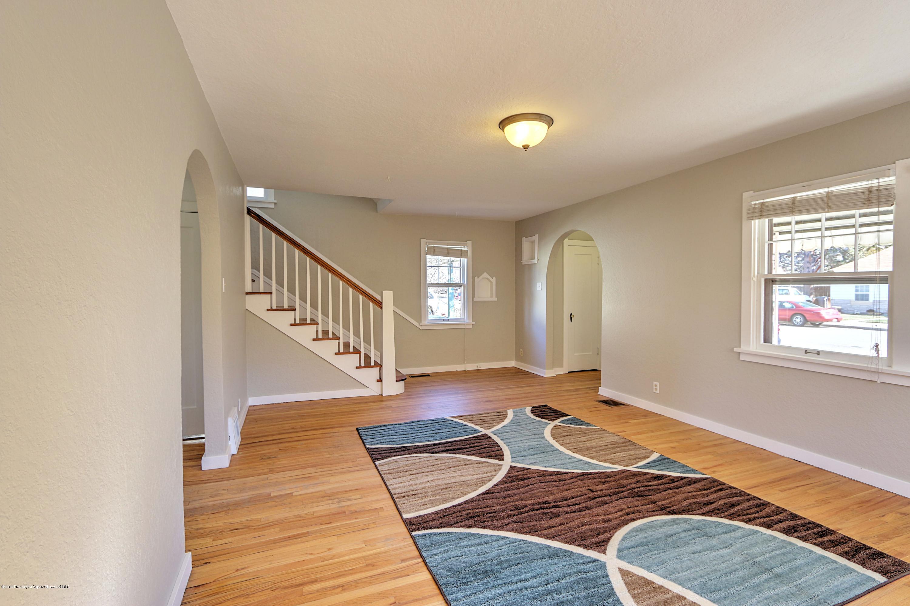 721 East Avenue Rifle, CO 81650 - Photo 7 of 24 a view of an empty room with wooden floor and window